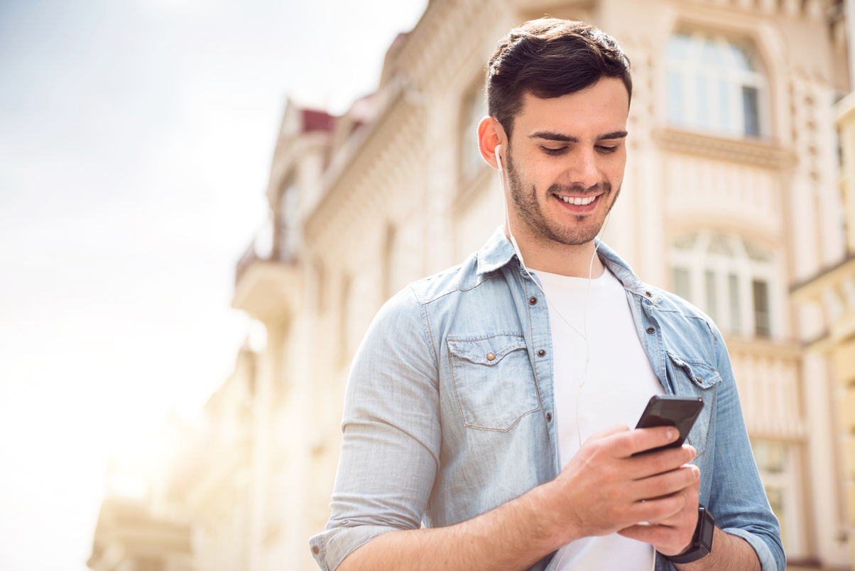 Positive man holding cell phone